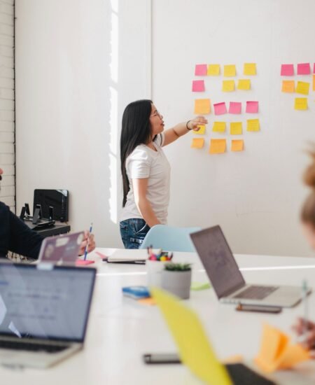 woman placing sticky notes on wall